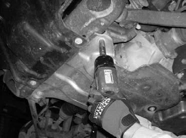 5. Working on the driver side, slide the stock torsion bar out of the stock rear lower control arm and set aside