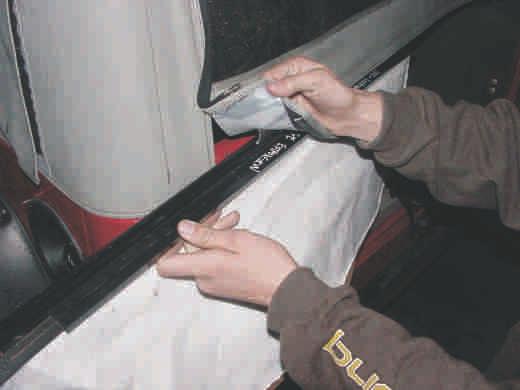 extrusion located on the bottom of the rear window. 12. Close the Rear Window zippers. 13.
