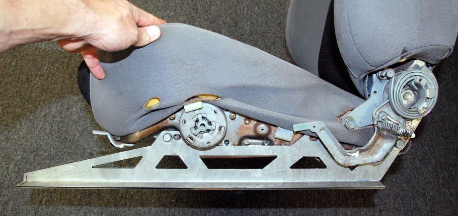 The left seat left side bracket is bolted on using OEM hardware with the lower rear hole and front slot.