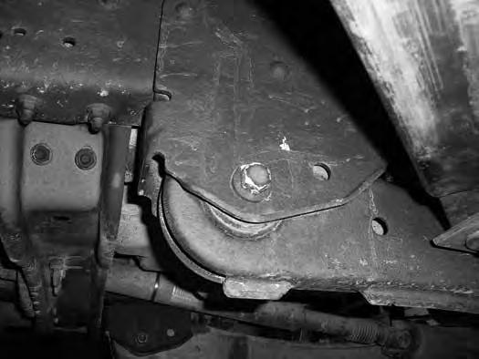 18. Starting with the passenger's side, remove the upper radius arm mounting bolt at the axle. It may be necessary to temporarily remove the shock from the axle mount to remove the bolt.