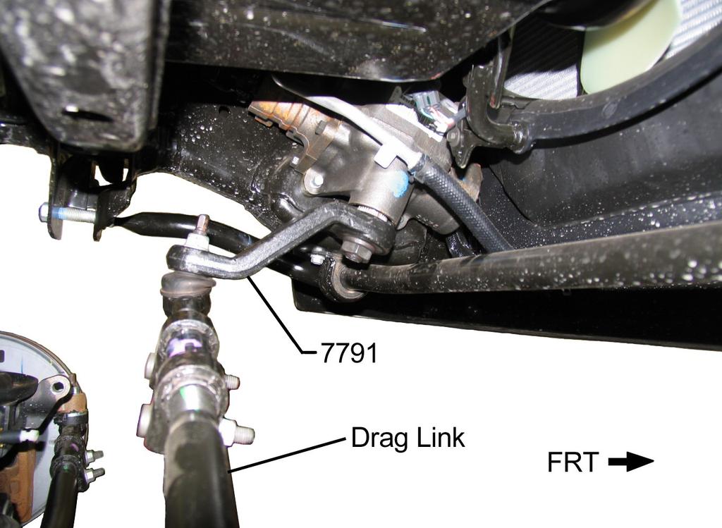 1) Using a quality spring compressor, compress left coil spring 702B, 708B or 815B. 2) Insert left coil spring between the driver side axle pad and upper mount. Align spring with reference marks.