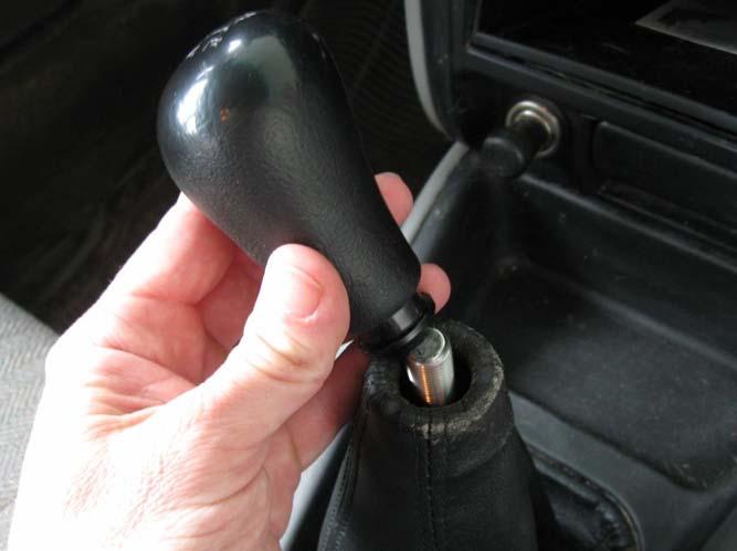 The boot opening will stretch enough to remove the shift knob.