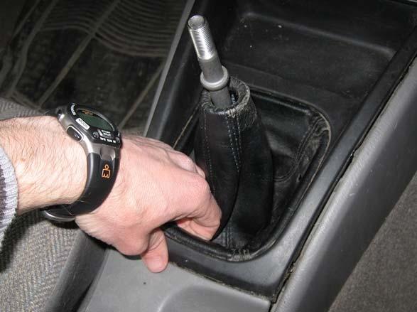Lift up on the shifter trim surrounding the shifter once the shift knob is removed.