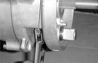 Install and tighten the brake arm bolt. Align the wide groove on the wear indicator plate with the wide tooth of the brake cam.