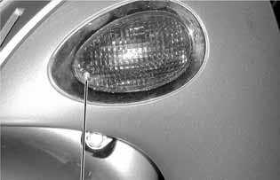 (2) Remove the two screws attaching the headlight. Remove the headlight unit. Remove adjust the headlight beam bolt.