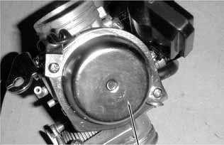 Be sure to set the vacuum diaphragm lip into the groove on the carburetor.