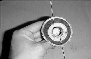 5. FUEL SYSTEM Push the needle holder in and turn it left to remove the needle holder.