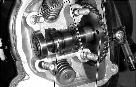 7. CYLINDER HEAD/VALVES Remove the four cylinder head nuts and washers.