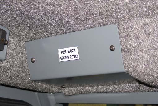 (CAB OPTION) The cab fuses are located in the fuse box inside the cab. Remove the fuse cover to access the fuses.