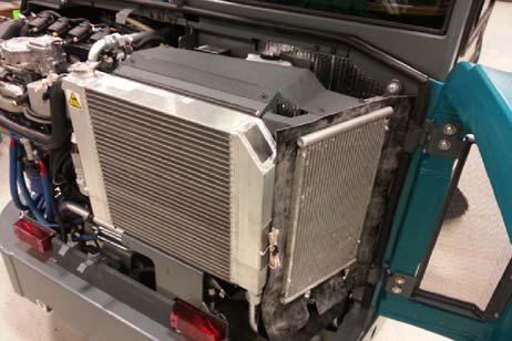 Check the radiator core exterior and hydraulic cooler fins for debris after every 100 hours of operation.