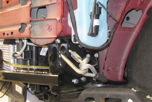 BX1728 11. Attach the permanent baseplate safety cables to the provided convenience link on the baseplate. The photo above shows the recommended installation of the cables to frame of vehicle.