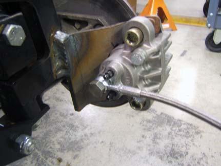 B) Move Tie Rod Extender down spindle arm towards wheel.