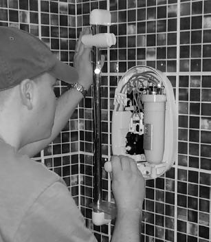 4 An electrician is replacing an old electric shower with a new one. The inside of the old shower is shown in Figure.