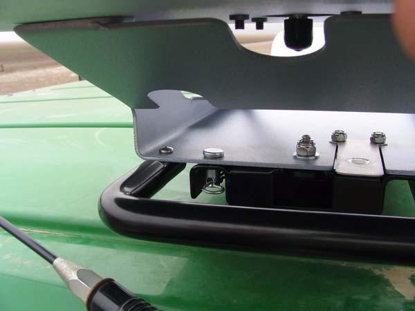 Insert and close the locking pin through the holes in the roof module