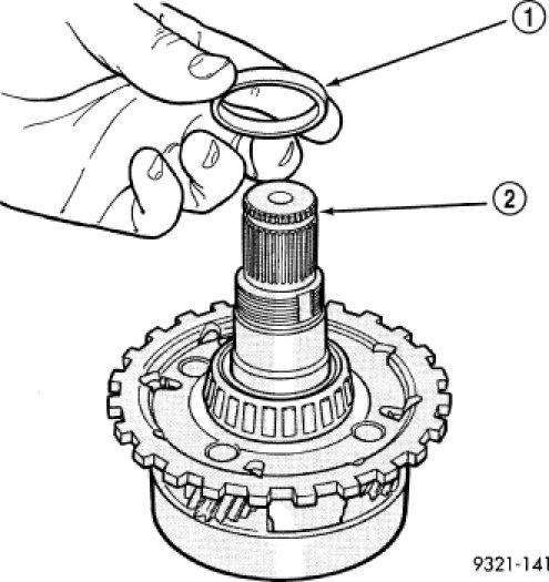16. Install shim (1) on output shaft (2). Apply small amount of petrolatum onto the shim to hold it in place. Use the original shim as a starting point.