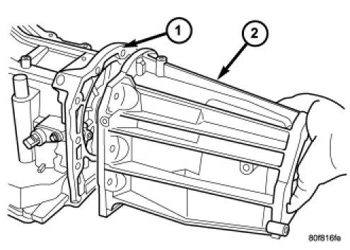 6. Remove the extension (2) housing, 4X2 vehicles only, from the transmission case.
