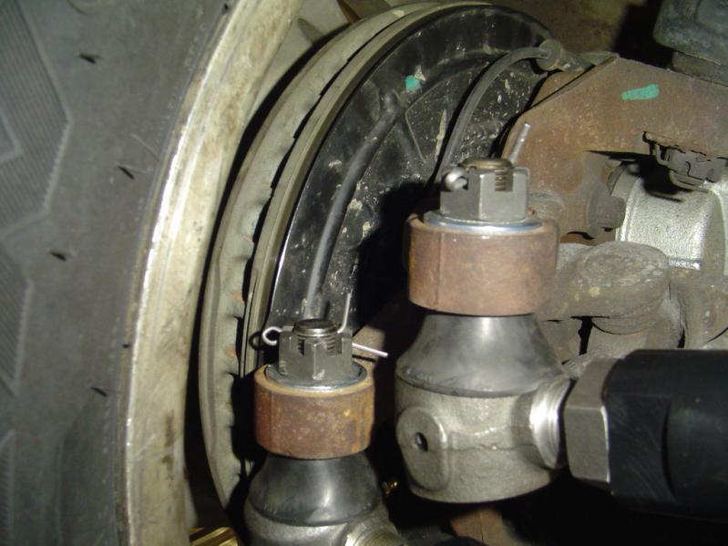 2) Disconnect the steering stabilizer from the steering stabilizer bracket. 3) Remove the steering stabilizer bracket from the OEM tie rod and save it for reuse.