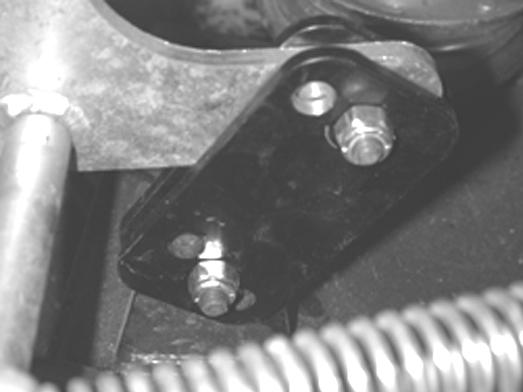 2. Using a 1/2" Wrench, adjust the Deck from front to rear as needed by moving the Top and/or the Bottom Bolt to a different Hole in the Rear Adjustment Bracket (Figure 25). 3.