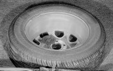 Storing the Flat Tire and Tools CAUTION: Storing a jack, a tire or other equipment in the passenger compartment of the vehicle could cause injury.