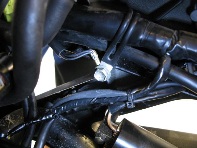 7. Next, route the remaining leads from the fuel harness to the front of the bike. Locate the 10mm bolt on the inside of the left frame rail, near the front cylinder ignition coil.