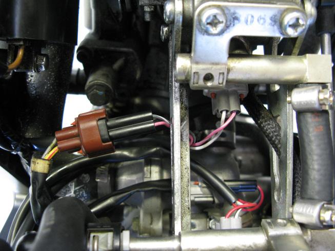 Continue routing both Bazzaz injector leads to the center of the throttle bodies, between the cylinders.