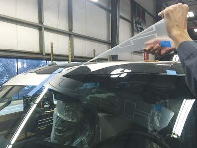 7. Carefully peel the outer covering off of the applied portion of the windshield banner but do not go