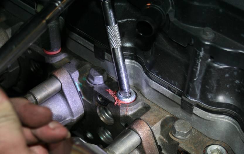 Tighten the plug bolt, then tighten the coolant hose