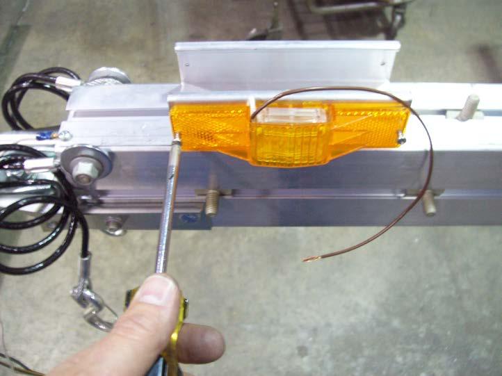 Install the running lights into the pre-drilled holes in the running light bracket
