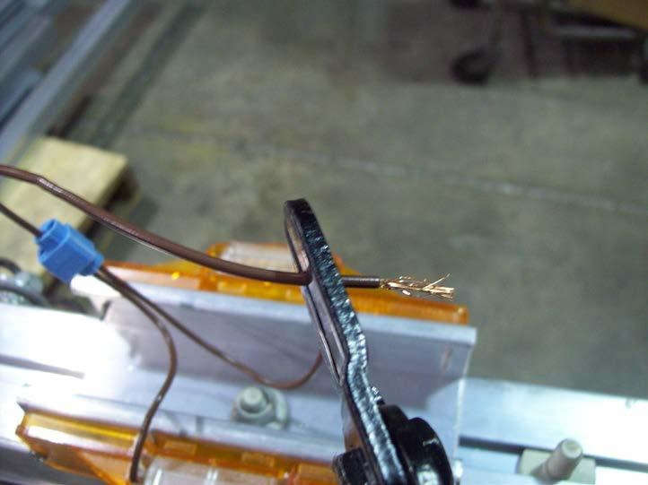Cut the exposed strands of wire off the end of the brown wire