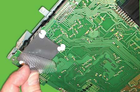 To ensure proper PCB placement, align the three alignment tabs and bolt holes. ALIGNMENT TAB 16. Carefully remove the protective cover from the gray thermal pad on the replacement PCB. 17.