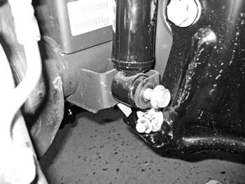 Figure 6 11. Raise the front axle and reattach stock shocks with factory bolt. It is not necessary to put the nut tab back on. The shocks will be there to keep the axle secure.