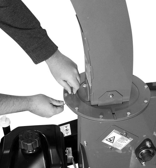 OPERATION Adjusting the Extended Top-Discharge Chute Discharge Direction: 1. Pull the Hitch Clip and remove the Locking Pin (Figure 67). 2.