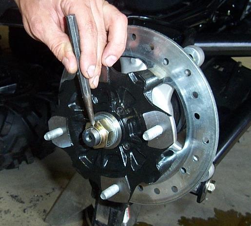 nut, using a punch to lock the axle nut in place.