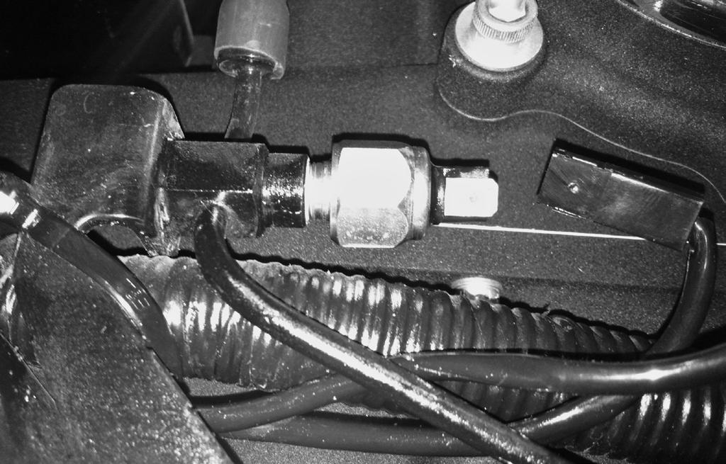 mount bolts. Ensure that the oil cooler mounting bracket is behind the lock washers. (Photo 1.) 24.