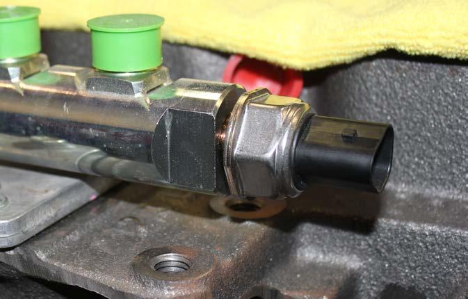 STEP 10 Locate the fuel rail pressure sensor located at the back of the factory fuel rail. Disconnect the electrical connection from the sensor and carefully remove the sensor from the fuel rail.