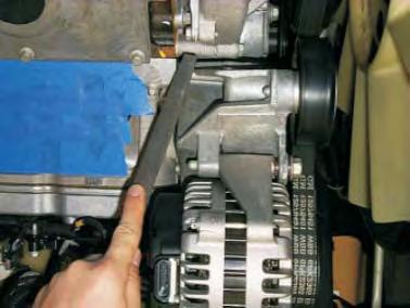 45. Using a file or die grinder, remove material from the alternator mounting bracket marked in the