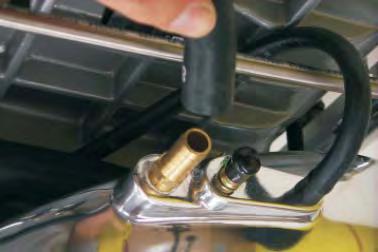 53. Install the power brake hose and clamp removed in the previous step to the large