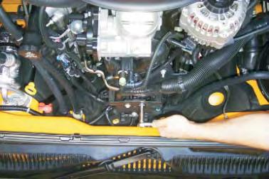 17. Using a 10mm socket wrench, remove the three bolts that fasten the