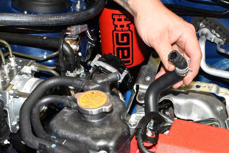 The IAG AOS upper coolant line will attach to the OEM coolant expansion tank.