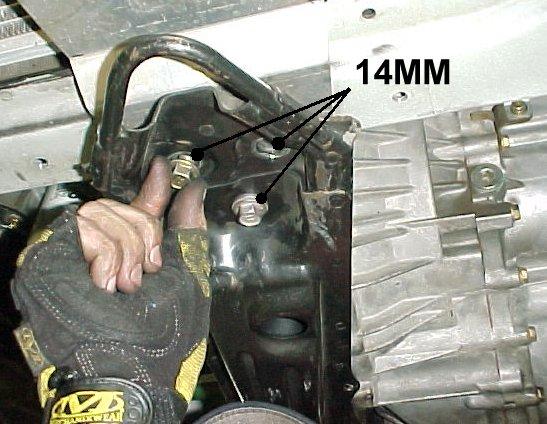 5) Use a 14mm wrench or socket to remove the three bolts holding