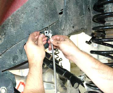 31.Install the supplied pin on the axle as shown in Photo 13 using a screwdriver as shown and a 3/4 wrench. 32.