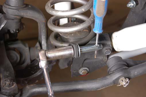 When disconnecting the sway bar, remove the sway bar link / washer and place it on the frame mount as shown in Photo 16 to keep the sway bar link from interfering with front end components.