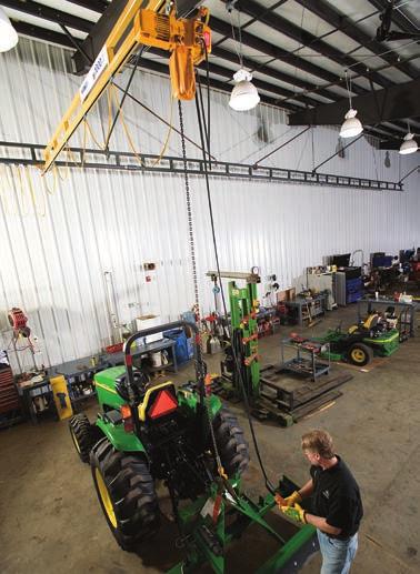 A John Deere dealership replaced a jib crane and forklifts with a Spanco Ceiling-Mounted Bridge Crane that covers their entire service area.