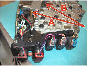 14) Install the auxiliary valve body assembly and the two tubes into the lower valve body section.