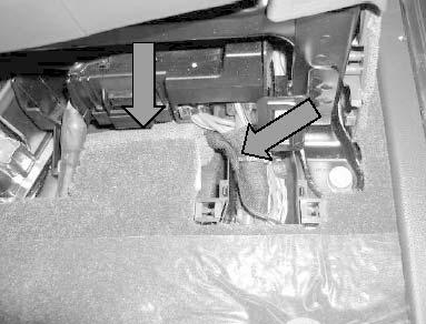 Route disconnected (foam covered) wiring as shown (arrows) and tie-wrap as necessary. Install carpeted cover. Return driver seat to normal position.