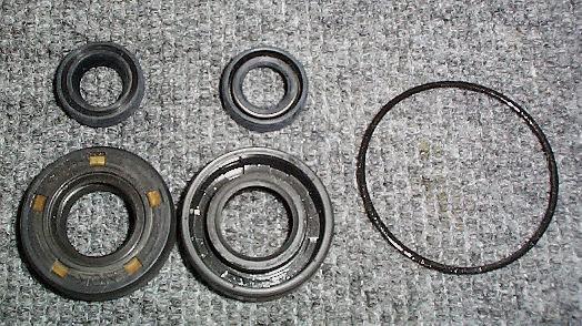 Check Crankshaft Oil Seals for signs of damage, wear or leakage. Replace as needed. Install with spring side toward oil.