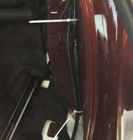 Using a flexible pickup tool, route the harness between the front and rear door behind the panel following the existing wiring harness (Fig.