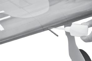 edge, at the fuselage sides. 3. Turn the airplane upside down.