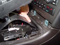 Ensure that the front edge of the shifter slider track is properly fed under the front edge of the center console and then snap the shifter cover plate back onto the shifter base.