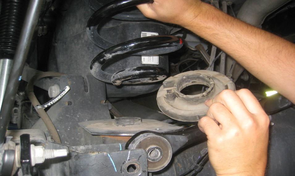 51. Re-install the OE rubber isolator and coil spring on both sides of the vehicle. 52.